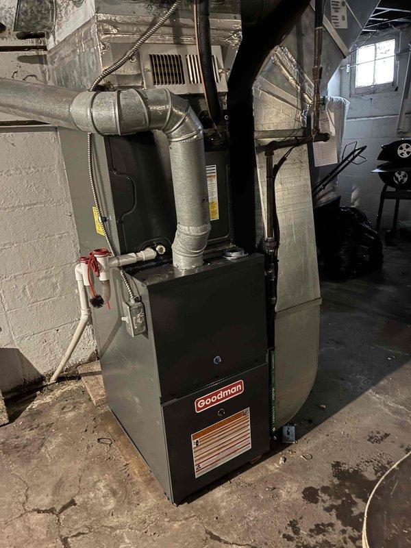 Successfully installed new Goodman furnace in basement utility room, including connection of all required ductwork, electrical components, and gas line. Unit was properly mounted against concrete wall with appropriate clearances and all connections were tested to ensure proper functionality.