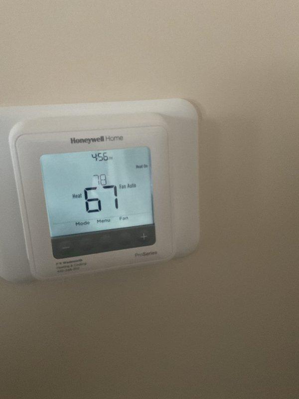 Responded to service call regarding thermostat programming issues. Diagnosed Honeywell Pro Series thermostat that was stuck in program mode. Inspected furnace operation, confirming proper flame pattern in burner assembly and verifying electrical connections were secure. Successfully reset thermostat programming and confirmed system now functions correctly in manual mode.