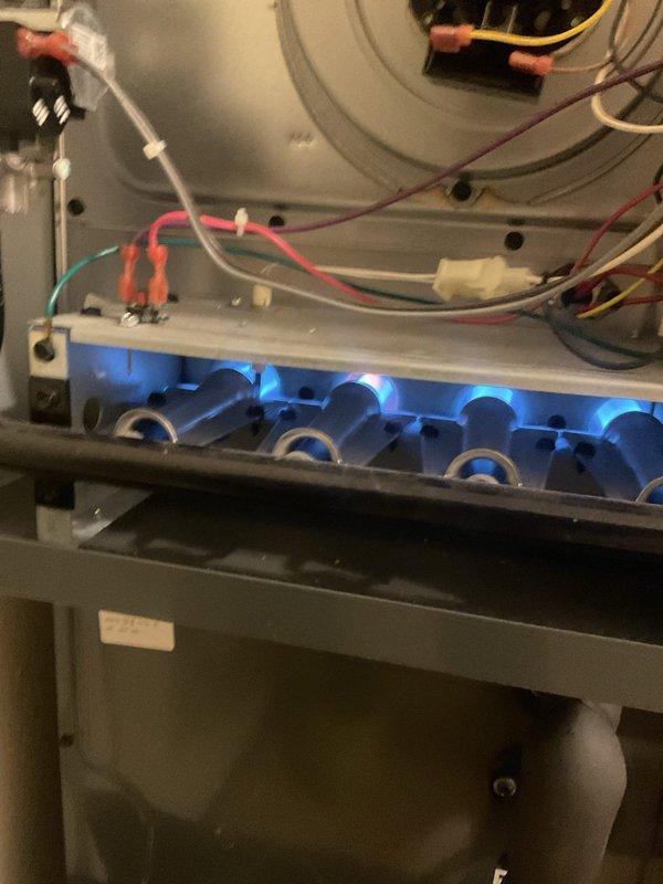 Responded to service call regarding thermostat programming issues. Diagnosed Honeywell Pro Series thermostat that was stuck in program mode. Inspected furnace operation, confirming proper flame pattern in burner assembly and verifying electrical connections were secure. Successfully reset thermostat programming and confirmed system now functions correctly in manual mode.