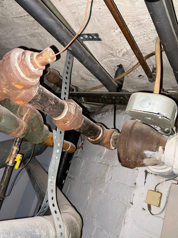 Performed diagnostic assessment on non-functioning boiler system. Documented existing plumbing infrastructure showing aged copper pipes with significant oxidation and examined pressure regulation components. Presented replacement options to customer who indicated they are evaluating multiple estimates for resolving the no-heat situation.