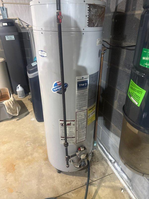 Performed comprehensive plumbing inspection of residential water heating system, including Bradford White water heater installation, expansion tank, and associated copper/PVC piping connections. Verified proper installation of gas valve assembly and ventilation components, confirming system meets operational standards.