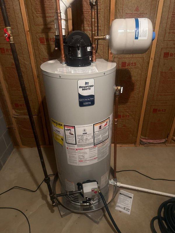 Performed comprehensive plumbing inspection of residential water heating system, including Bradford White water heater installation, expansion tank, and associated copper/PVC piping connections. Verified proper installation of gas valve assembly and ventilation components, confirming system meets operational standards.