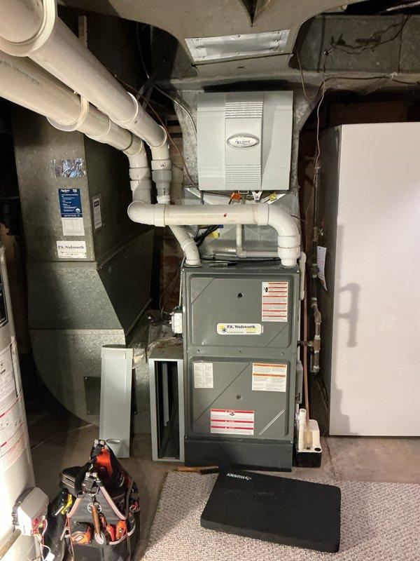 Performed scheduled heating maintenance on furnace system. Inspected and replaced air filters with new pleated filters to ensure proper airflow. Examined complete HVAC setup including furnace, humidifier, and associated PVC venting system - all components functioning normally with no issues detected.