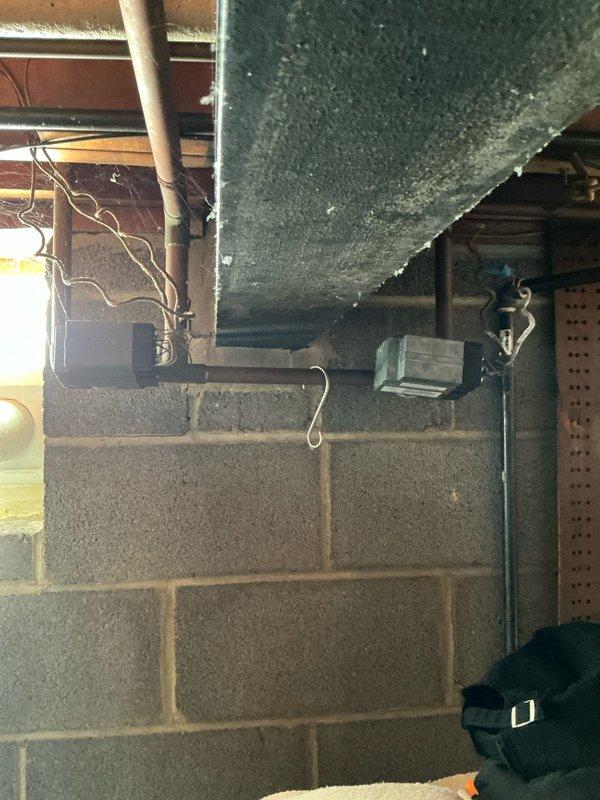 Conducted site assessment of existing boiler system in basement utility area. Inspected copper piping infrastructure, water tank with insulation, and examined connection points with visible tags. Documented condition of ventilation components and electrical connections to provide comprehensive replacement estimate.