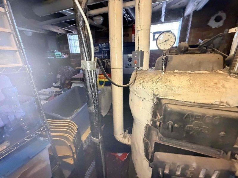 Responded to service call for APCO boiler leaking water that customer had shut down. Upon inspection of the aging unit, found water leakage around base of system. Identified failed gasket at circulation pump connection as source of leak, replaced gasket and checked all associated valves and pressure readings. System restored to proper operation with no further leaks detected.