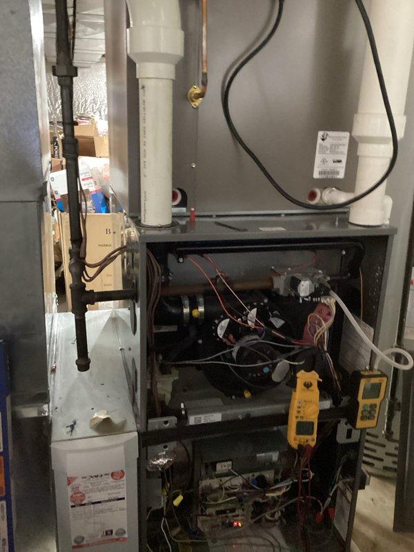 Performed scheduled maintenance on heating system, which included opening the furnace to inspect internal components and wiring. Conducted electrical diagnostics using a PRO DL379 multimeter, measuring voltage readings of 0.38V and 0.20V to verify proper electrical function of the system.