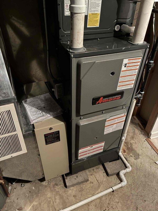 Successfully completed full HVAC system replacement with installation of a new 96% efficiency Amana furnace and matching air conditioning unit. System includes properly installed PVC ventilation pipes and condensate drainage, with all ductwork connections secured and sealed according to manufacturer specifications.