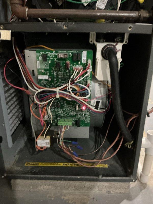 Performed scheduled heating maintenance service on residential furnace system. Inspected control boards, electrical connections, and wiring harnesses, confirming all components were properly secured and functioning normally. Verified blower motor assembly operation with no issues detected in the electronic control systems.