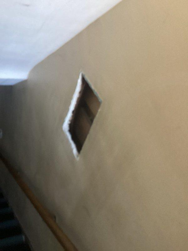 Conducted assessment of moisture-affected soil area with organic debris accumulation, potentially impacting underground electrical components. Created diamond-shaped access point in wall to inspect and service concealed wiring or junction box, allowing for proper evaluation of electrical system integrity in the affected zone.