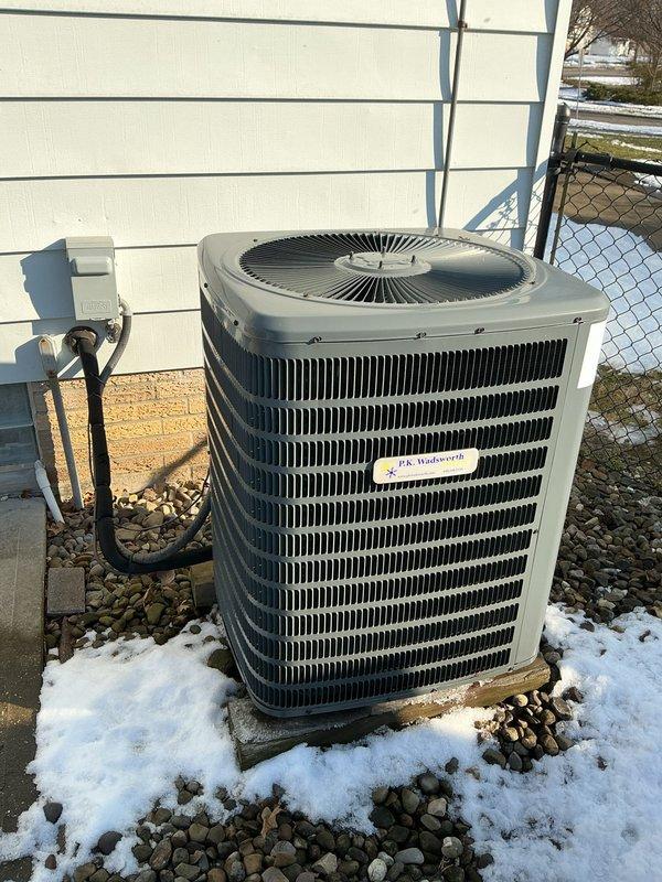 Completed preventative maintenance on Goodman heating system. Inspected outdoor condenser unit, which was properly mounted on platform with adequate clearance and functioning normally. No issues identified with electrical connections or system operation.