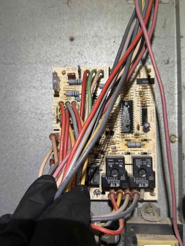 Diagnosed and repaired 15+ year old furnace exhibiting no-heat condition with blower operation but failed ignition. Inspection revealed error code on circuit board indicating ignition failure, requiring removal and cleaning of flame sensor to restore proper flame detection and system operation.