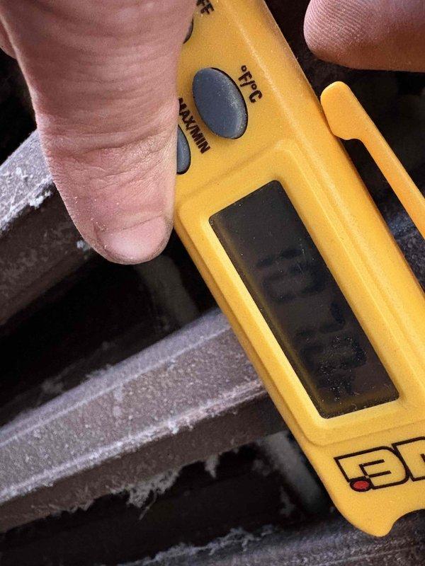 Completed boiler service finance agreement. Conducted temperature diagnostics with PDT650 thermometer, measuring supply air temperature (110.4°F) at decorative lattice vent and checking refrigerant line temperature (5.3°) for proper system operation. Documentation photos taken of all diagnostic points.