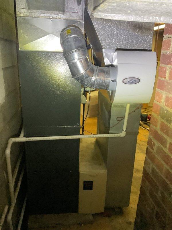 Performed routine maintenance on heating system with Aprilaire whole-house humidifier. Inspected furnace unit, checked digital control panel functionality, and verified proper connection of ductwork. System is operating within normal parameters with all connections secure.