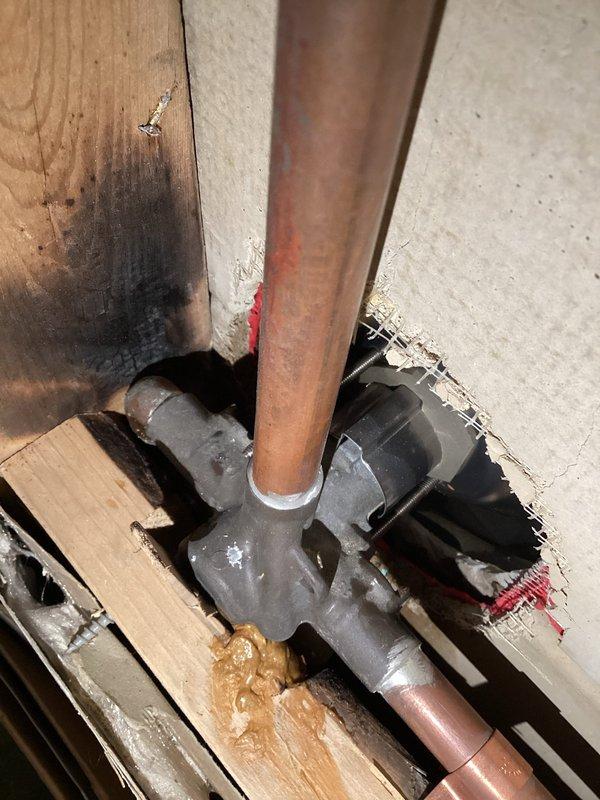 Performed diagnostic assessment of burst copper pipes in basement ceiling that caused ceiling collapse. Inspection revealed oxidized copper supply lines with compromised joints showing signs of failure at T-junction connection. Documented evidence of water damage to surrounding wooden structural members with photographic evidence suitable for insurance claim documentation.