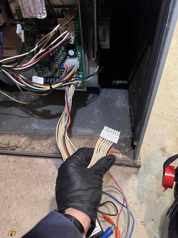 Responded to no-heat call and diagnosed malfunctioning furnace blower motor. Inspected control board connections and found loose wiring harness at the circuit board terminals. Reconnected the multi-pin connector to restore proper electrical continuity, verified system operation, and confirmed heat was restored to residence.