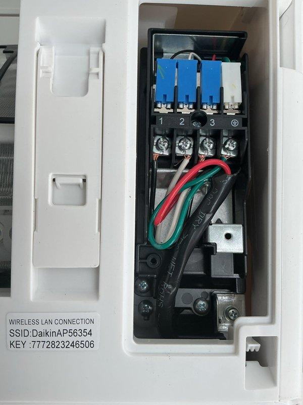 Responded to warranty call regarding Daikin mini-split system with electrical compartment issue. Upon inspection, found bulging wires preventing proper closure of the access panel on the indoor unit. Adjusted wire routing and secured connections at terminal block to allow proper panel closure and ensure system functionality.