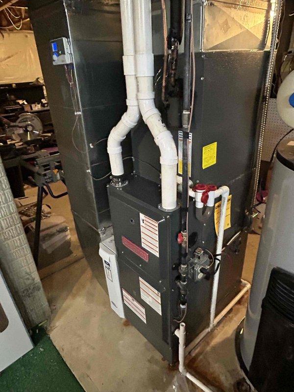 Successfully installed replacement furnace with proper flue pipe inspection and configuration. Installed and connected Aprilaire control system with appropriate wiring. Verified proper ventilation through the dual PVC Y-configuration exhaust system and ensured all connections were properly sealed with metal tape at seams.