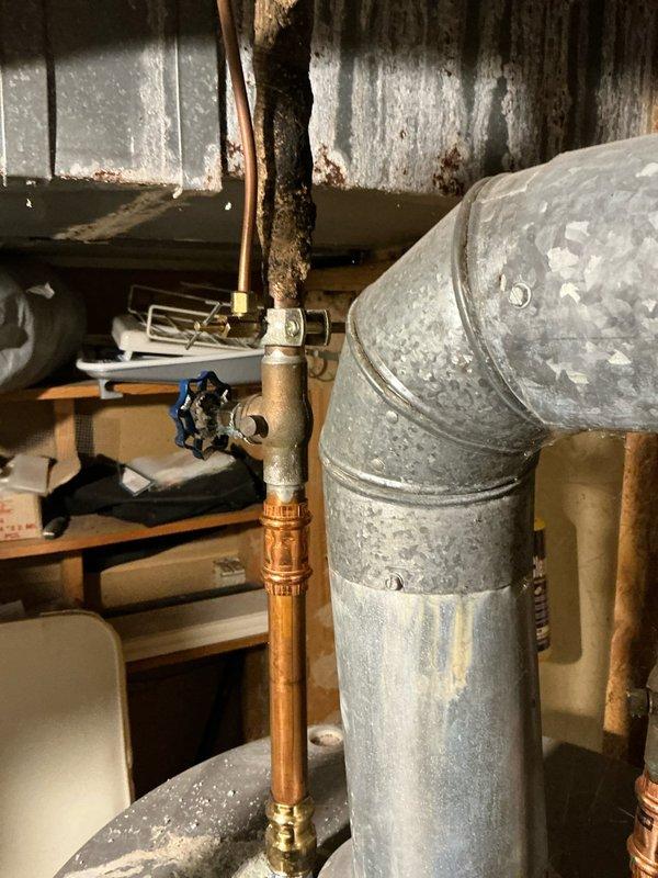 Inspected non-functioning furnace system in basement utility area. Identified complete system failure requiring replacement. Documented existing installation including galvanized ductwork, copper line connections, and current unit placement for proper replacement specifications.
