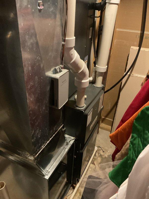 Performed scheduled heating maintenance on residential furnace system. Inspected internal electrical components including wiring connections and blower motor assembly. Examined ventilation configuration with PVC exhaust piping and verified proper installation of control sensor.