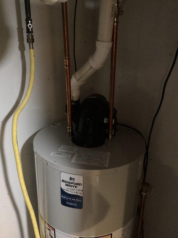 Completed routine plumbing inspection with focus on water heater system and shut-off valves. Inspected Bradford White water heater installation including copper supply lines, PVC drain pipe, and gas connection. Verified proper function of main water shut-off valves located on pipes mounted to ceiling joists.
