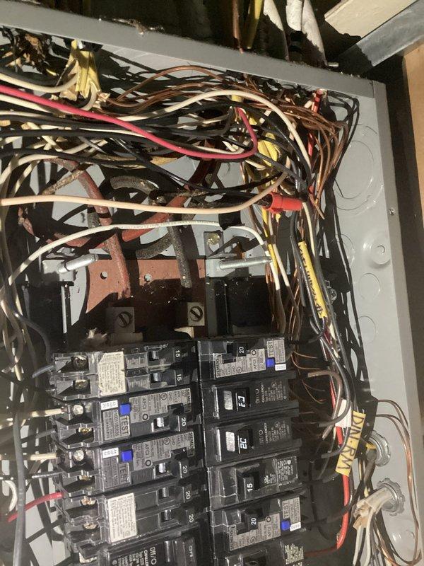 Conducted assessment of electrical panel requiring rewiring, noting significant wire congestion and suboptimal organization within the main breaker box. Exterior service panel inspection revealed potential weathering concerns at connection points and evaluated the current load capacity to determine appropriate rewiring specifications for improved safety and functionality.