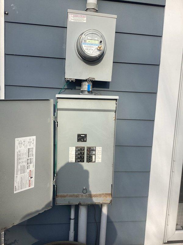 Conducted assessment of electrical panel requiring rewiring, noting significant wire congestion and suboptimal organization within the main breaker box. Exterior service panel inspection revealed potential weathering concerns at connection points and evaluated the current load capacity to determine appropriate rewiring specifications for improved safety and functionality.