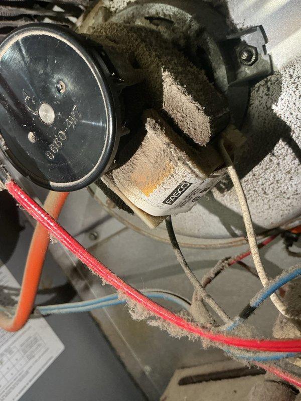 Performed routine heating tune-up and inspection of aging HVAC system. Noted significant rust and corrosion on metal housing components, particularly along edges and seams, indicating potential moisture exposure. Observed substantial dust accumulation on pressure/temperature gauge and internal components requiring cleaning to maintain optimal system performance.