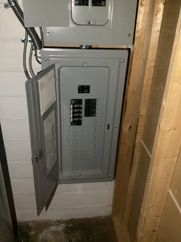 Completed installation of a new electrical line through the garage. Work included mounting and connecting a circuit breaker panel with multiple circuit breakers (15A and 20A), properly terminating all wiring (green, red, white, and black conductors), and ensuring all connections were secure. Verified proper function of all circuits upon completion.