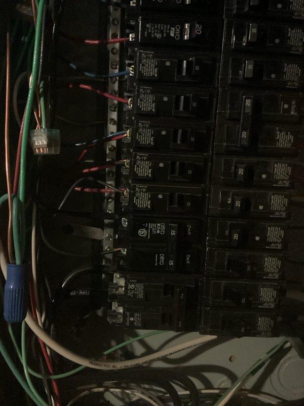 Completed installation of a new electrical line through the garage. Work included mounting and connecting a circuit breaker panel with multiple circuit breakers (15A and 20A), properly terminating all wiring (green, red, white, and black conductors), and ensuring all connections were secure. Verified proper function of all circuits upon completion.