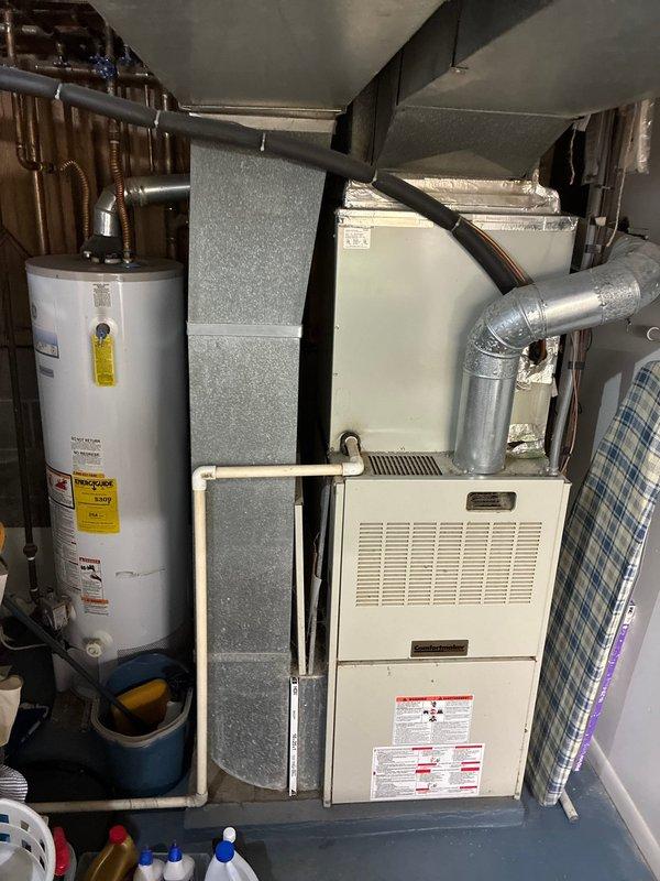 Conducted comprehensive site assessment for furnace replacement, including evaluation of existing HVAC system components and electrical service entrance. Documented current installation showing water heater proximity and existing ductwork configuration to determine optimal equipment placement and necessary modifications for new furnace installation.