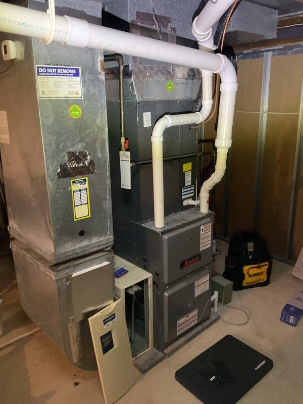 Performed comprehensive heating maintenance on aging HVAC system (10+ years old) in preparation for property listing. Inspected and cleaned pleated filter assembly, which had been previously secured with tape. Examined furnace unit, PVC ventilation piping, and air handler connections for proper operation, noting all warning labels were intact and visible. System is functional but showing expected signs of age-related wear.