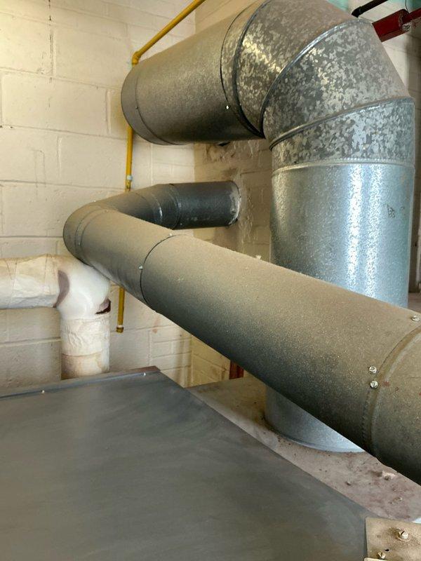 Conducted site inspection of non-operational steam boiler at church location. Examined existing HVAC ductwork in utility area and evaluated aging copper pipe system showing signs of corrosion and mineral buildup at multiple connection points. Documented current installation to prepare options for replacement of failing steam boiler system.
