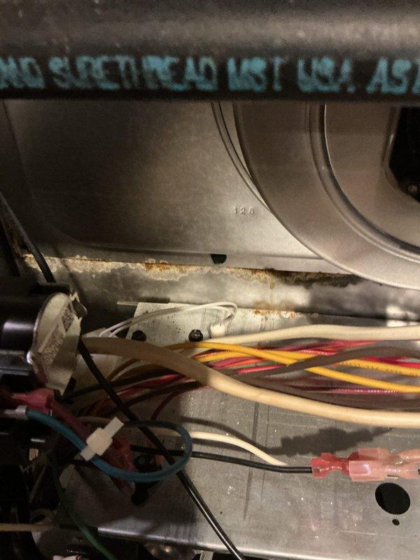 Performed scheduled maintenance on dual furnace heating system. Inspected electrical components and identified significant corrosion along metal seams and ductwork. Documented condition of wiring connections including multicolored control wiring with clear plastic connectors for future reference.