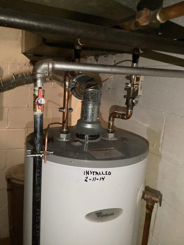 Replaced aging Whirlpool water heater (originally installed 2-11-19) due to diminished heating performance and brown water discharge. Installed new tanked water heater with proper connections to existing copper supply lines and vent pipe. System now functioning with clear water output and optimal heating capability.