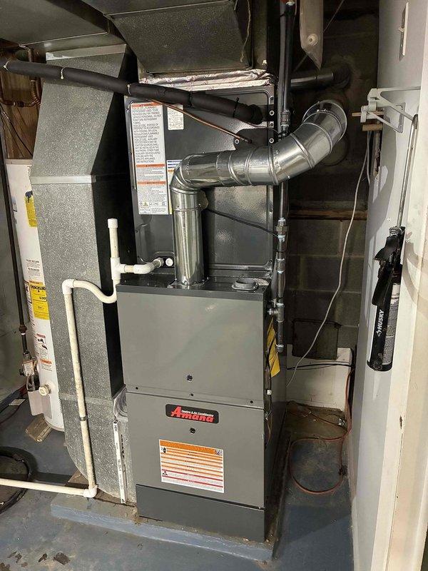 Successfully installed complete HVAC system including Amana 80% efficiency furnace with proper ductwork and metal exhaust venting in utility area. Exterior installation of Trane condensing unit completed on level pad with all necessary connections to create a fully functional heating and cooling system.