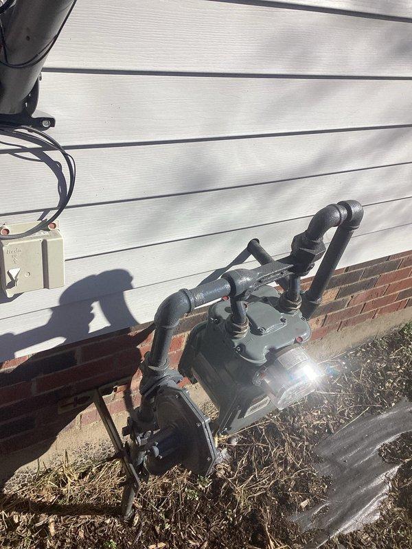 Performed site assessment for generator installation, documenting existing gas meter configuration and utility connections. Identified appropriate mounting location against exterior wall with proper clearance from foundation. Prepared installation plan considering electrical junction box positioning and required connections to household systems.