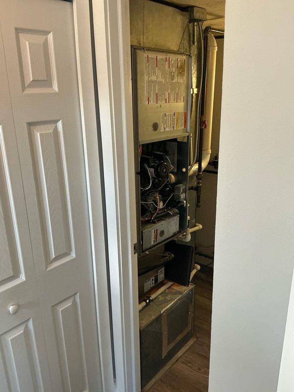 Conducted comprehensive HVAC assessment and presented three-tier replacement options for aging system: Good (13.4 SEER/80% AFUE), Better (14 SEER/96% AFUE), and Best (16 SEER/96% AFUE) Goodman A/C and Gas Furnace packages. Documented existing installation with photos showing furnace with access panel open revealing internal components and specification labels, plus exposed wall cavity with plumbing connections and electrical infrastructure requiring attention during replacement.