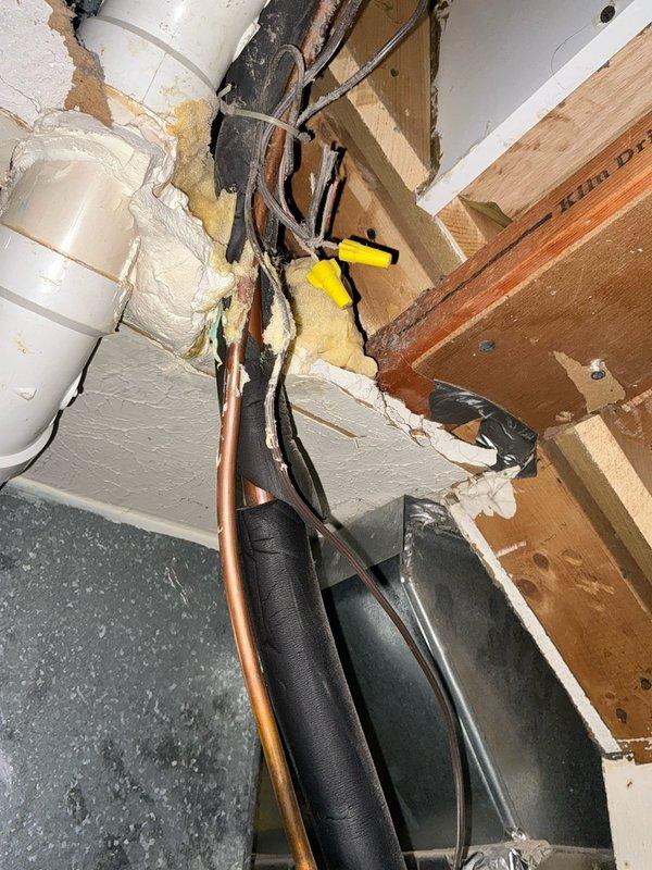 Conducted comprehensive HVAC assessment and presented three-tier replacement options for aging system: Good (13.4 SEER/80% AFUE), Better (14 SEER/96% AFUE), and Best (16 SEER/96% AFUE) Goodman A/C and Gas Furnace packages. Documented existing installation with photos showing furnace with access panel open revealing internal components and specification labels, plus exposed wall cavity with plumbing connections and electrical infrastructure requiring attention during replacement.