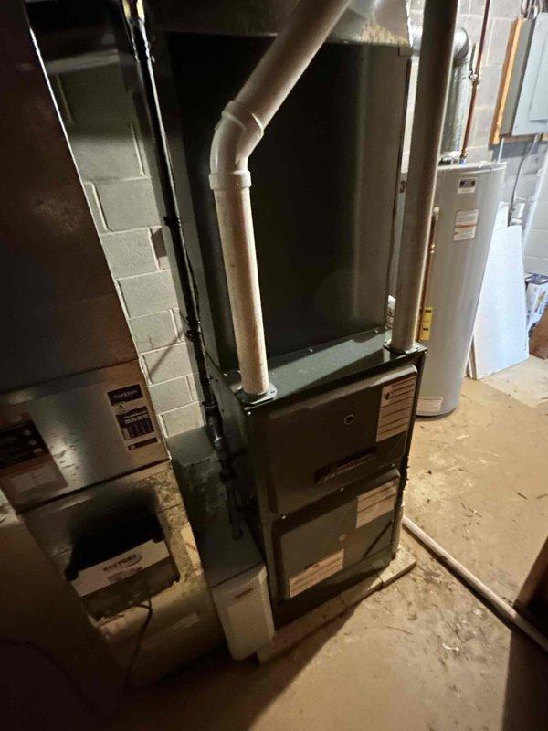 Successfully installed a complete 96% efficiency furnace system with air conditioning unit, AprilAire humidifier, and duct liner. The installation included proper PVC ventilation piping and connection to existing ductwork. Humidifier control was mounted and tested, confirming proper functionality with digital display showing 25% humidity level.