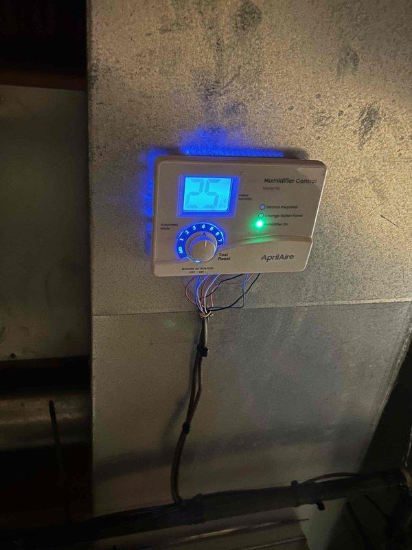 Successfully installed a complete 96% efficiency furnace system with air conditioning unit, AprilAire humidifier, and duct liner. The installation included proper PVC ventilation piping and connection to existing ductwork. Humidifier control was mounted and tested, confirming proper functionality with digital display showing 25% humidity level.