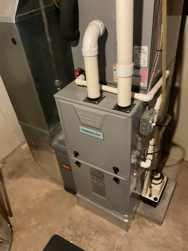 Completed routine heating maintenance service on Comfort-Aire/Division furnace system located in basement utility room. Inspected all components including PVC exhaust/intake pipes, condensate drain line, electrical connections, and associated ductwork. System was found to be in proper working condition with no issues identified.