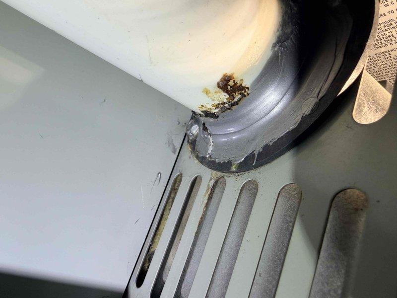 Responded to service call following home inspection findings. Identified significant corrosion and deterioration at the furnace condensate drain connection, with visible rust and residue buildup. Documented evidence of water damage and moisture exposure affecting the ventilation system components.