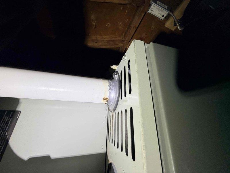 Responded to service call following home inspection findings. Identified significant corrosion and deterioration at the furnace condensate drain connection, with visible rust and residue buildup. Documented evidence of water damage and moisture exposure affecting the ventilation system components.