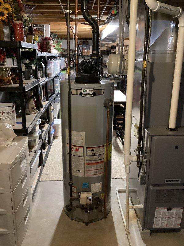 Completed scheduled maintenance on A.O. Smith tanked water heater, performing a comprehensive flush and fill service to remove sediment buildup. Properly drained system using appropriate containment method, then refilled and verified proper operation of the unit in basement utility area.