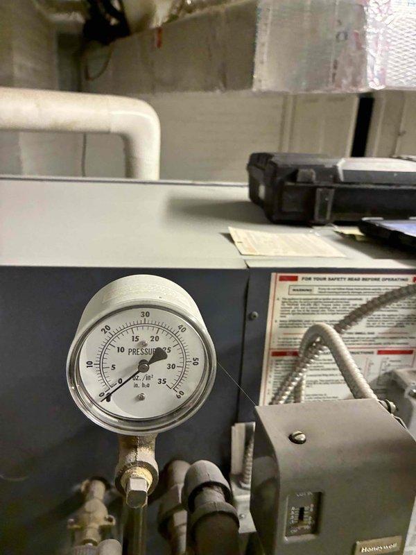 Performed scheduled boiler maintenance service including inspection of pressure gauge (reading approximately 2-3 PSI) and examination of internal components. Checked all connections, valves, and wiring within the unit, ensuring proper operation of the system. All parameters verified within normal operating range; no issues detected.