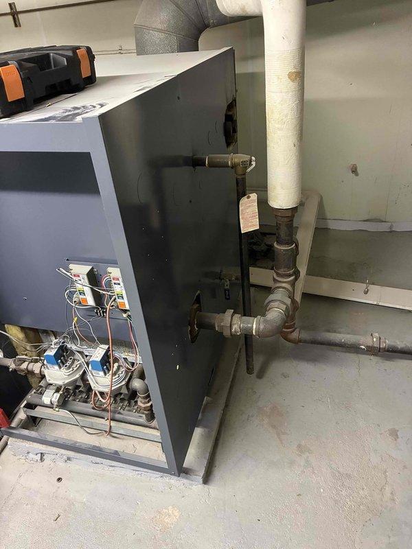 Performed scheduled boiler maintenance service including inspection of pressure gauge (reading approximately 2-3 PSI) and examination of internal components. Checked all connections, valves, and wiring within the unit, ensuring proper operation of the system. All parameters verified within normal operating range; no issues detected.