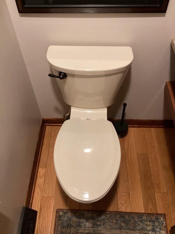 Conducted a routine plumbing inspection of residential bathroom facilities and mechanical room. Visual assessment of toilet installation confirmed proper mounting and functionality with no apparent leaks or issues. Inspected hot water heater system including tank condition, copper pipe connections, and associated valves - all components appear to be in good working order with no immediate maintenance concerns identified. Photographic documentation was taken for service records.