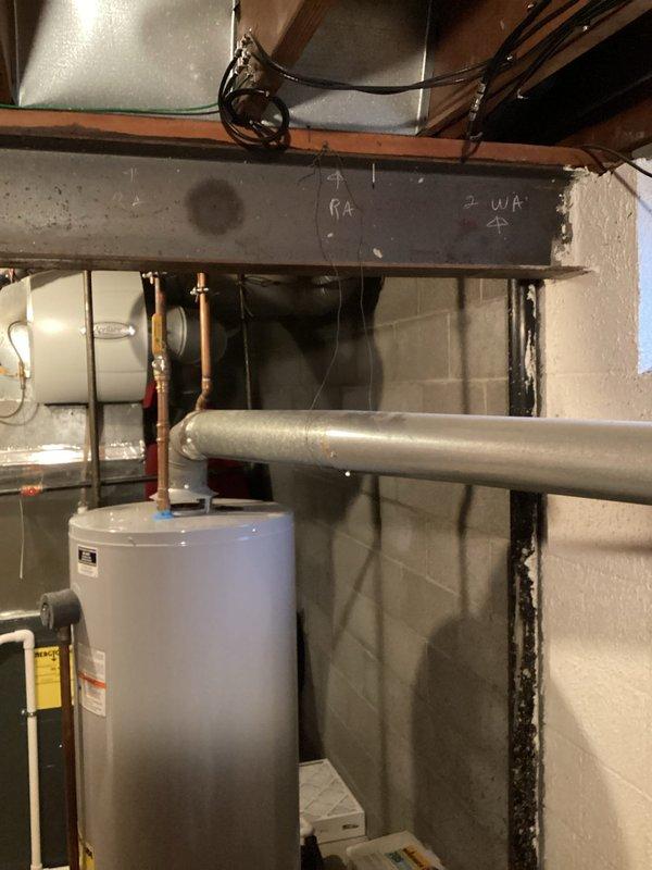 Conducted a routine plumbing inspection of residential bathroom facilities and mechanical room. Visual assessment of toilet installation confirmed proper mounting and functionality with no apparent leaks or issues. Inspected hot water heater system including tank condition, copper pipe connections, and associated valves - all components appear to be in good working order with no immediate maintenance concerns identified. Photographic documentation was taken for service records.