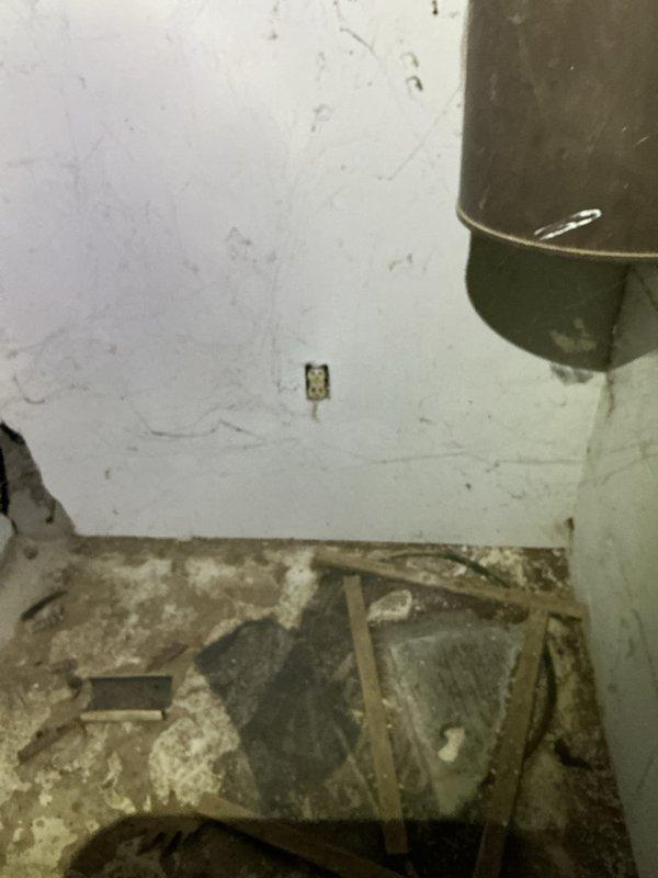 Conducted comprehensive electrical inspection of residential laundry room and basement utility area. Examined wall outlet connections for washer/dryer setup and inspected junction box in basement area, noting visible moisture damage on surrounding concrete walls. Documented conditions with photos for complete assessment.
