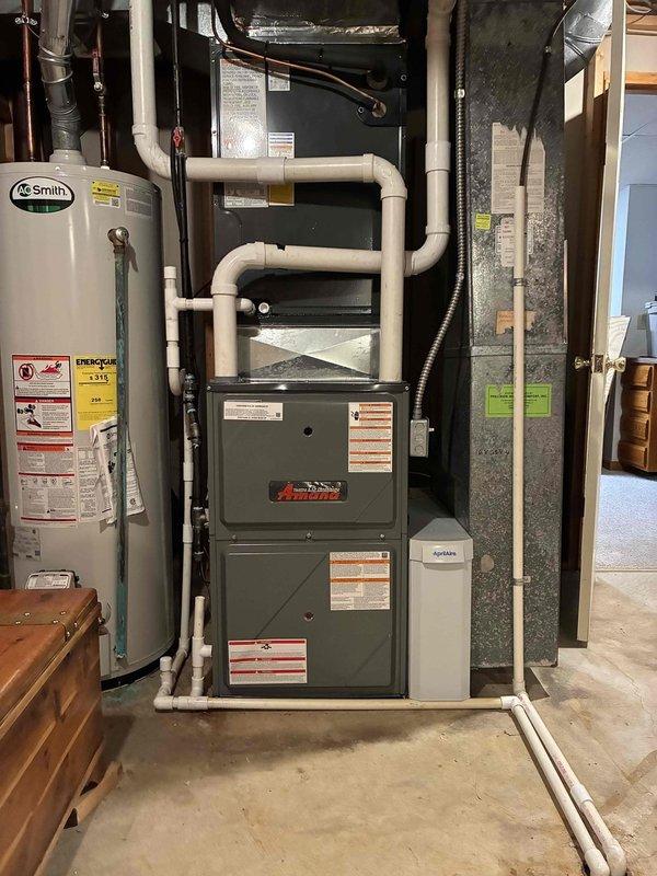 Successfully installed an Amana furnace unit in the basement utility room, including proper connection to existing A.O. Smith water heater and ductwork. All PVC ventilation piping and drainage systems were professionally routed and secured, with final system testing confirming proper operation of the new heating system.